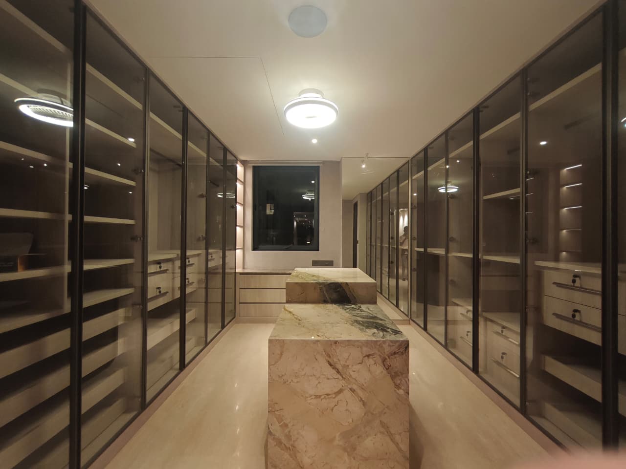 Walk-in closet with marble island built by Interio Mate, Bengaluru